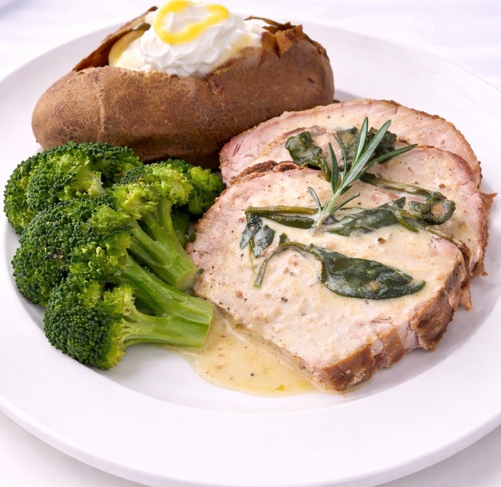 Herb-roasted pork with broccoli and baked potato