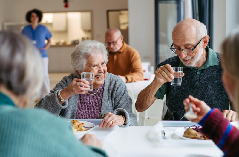 Residents sharing a meal together in the dining room at Covina Court Senior Living in Whittier, CA